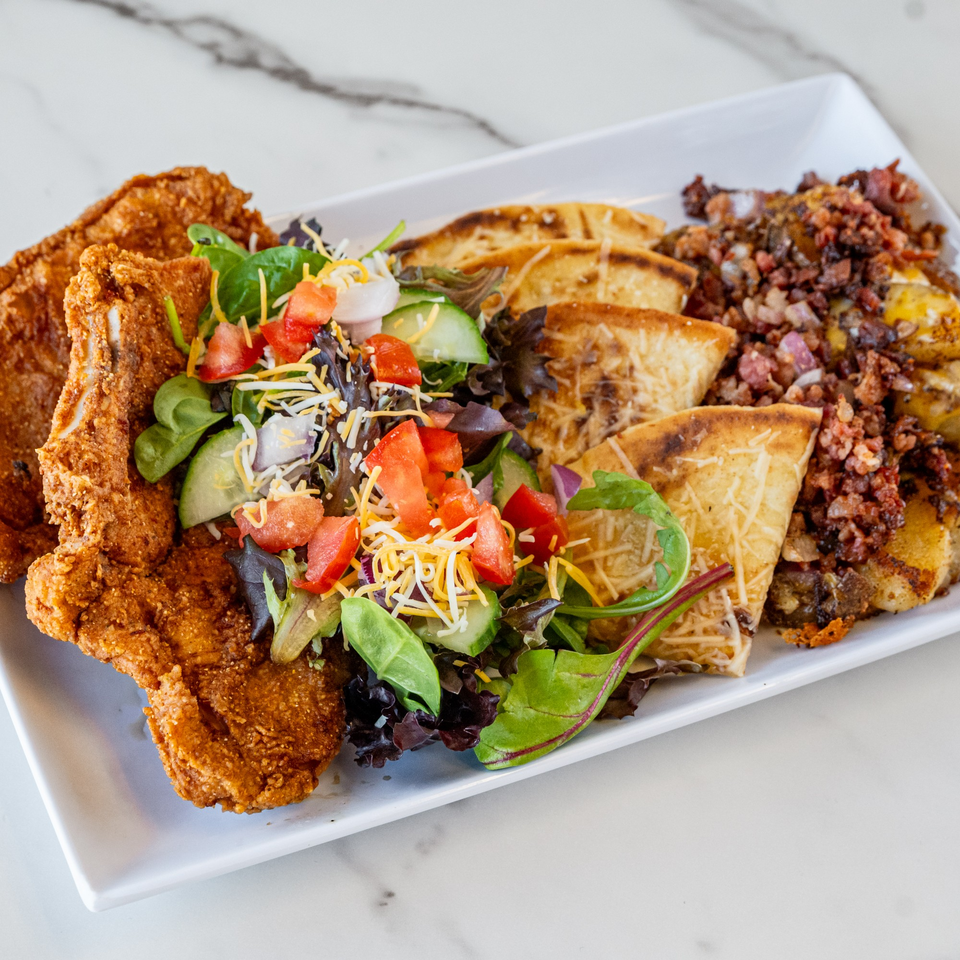 Urban Grill's fried chicken, side salad, cheesy flatbread, and breakfast potatoes with bacon.